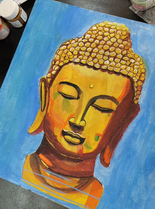 Golden Buddha face — acrylic painting on blue background